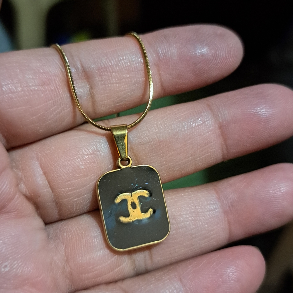 Gold-Tone Black Pendant Necklace with Interlocking Logo